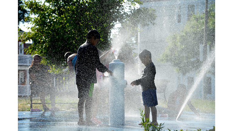 Children play at a splash pad 