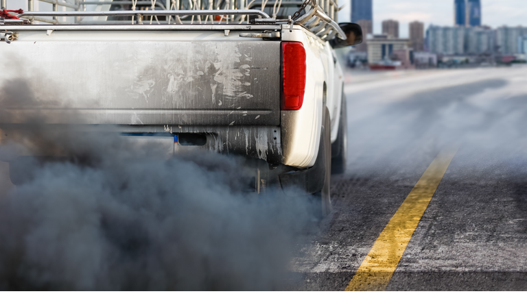 air pollution crisis in city from diesel vehicle exhaust pipe on road