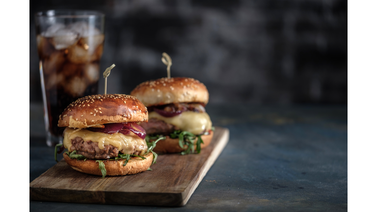 Homemade tasty hamburger with beef, cheese and caramelized onions. Street food, fast food. Copyspace