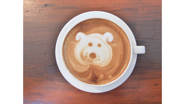 Latte Coffee art on the wooden desk.