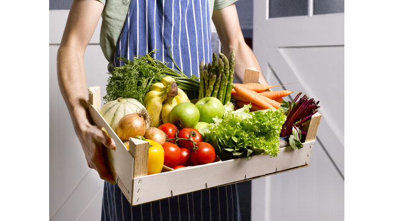 Man delivering fruit and vegetable box.