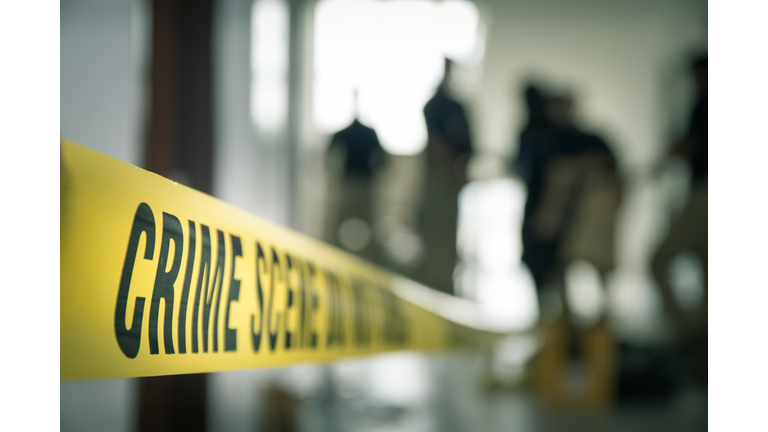 crime scene tape with blurred forensic in cinematic tone