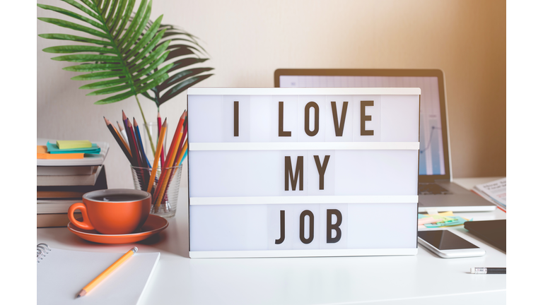 I love my job concepts with text on light box on desk table in home office