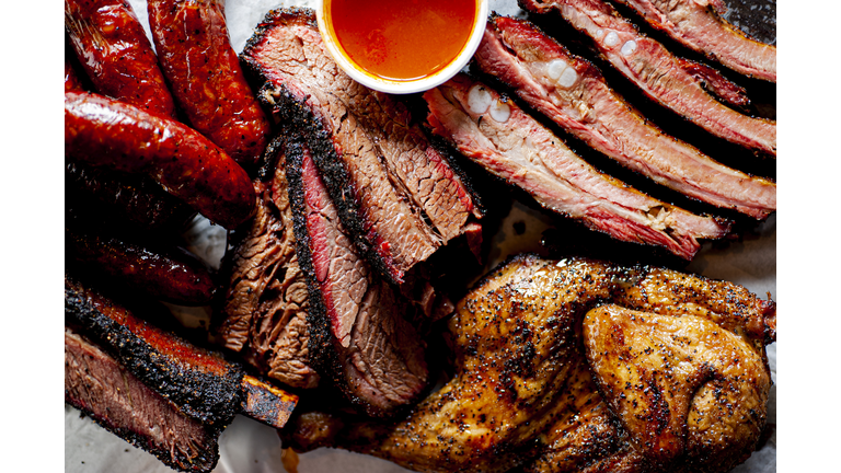 Barbecue. Barbecue table spread. Beef brisket, chicken, pork ribs, beef ribs, Mac n cheese, cornbread, Brussels sprouts, coleslaw & beer. Classic traditional Texas meats & side dishes.