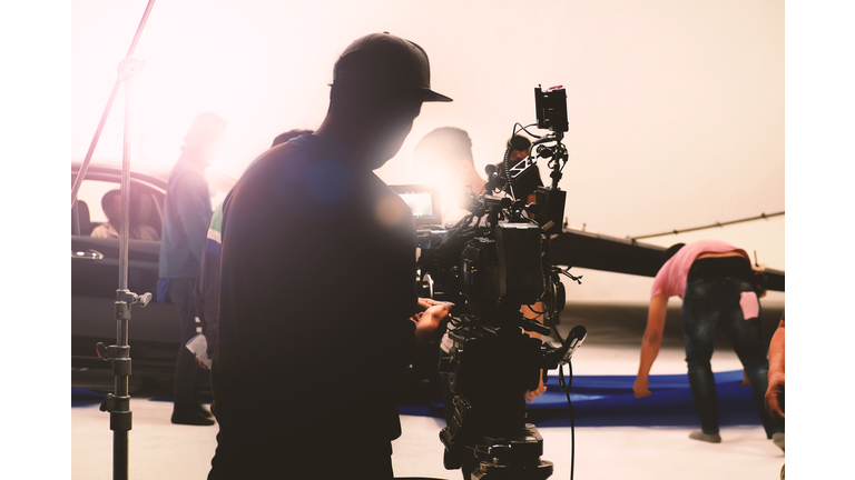 Video camera in film or movie production on tripod and professional gear which shooting in location or studio with crew team and beautiful prop or set and ready to online live broadcast or tv on air