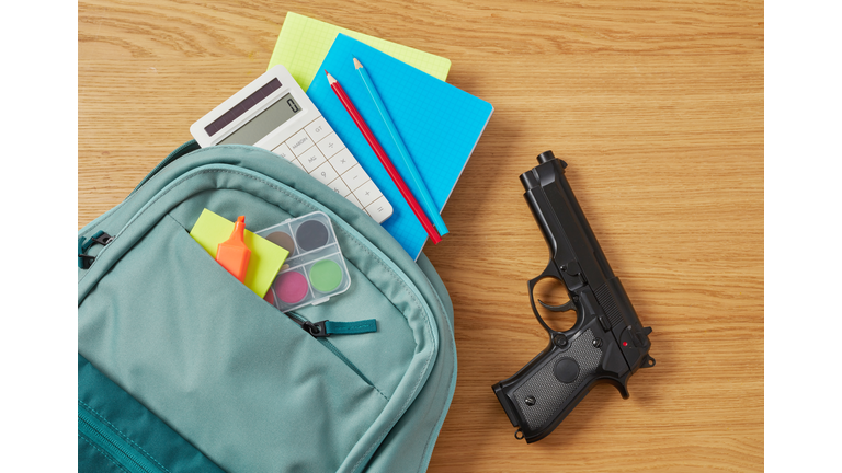 Backpack, school supplies and gun