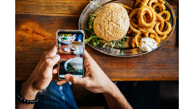 Man Talking Picture Of Burger With Smartphone