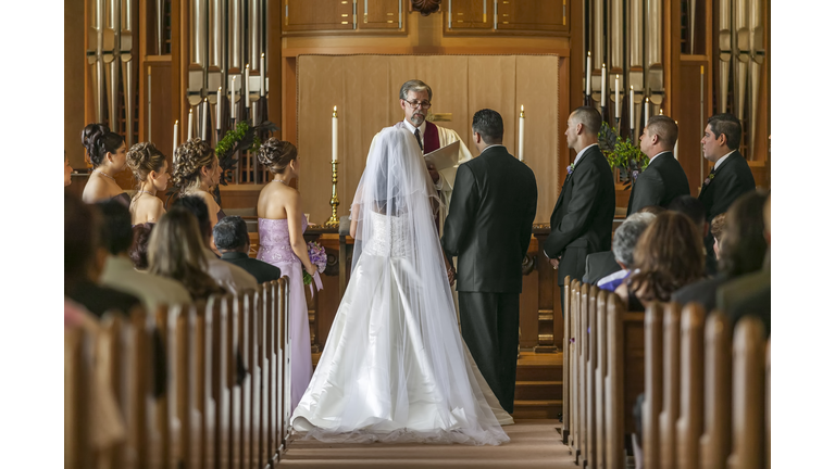 Bride and groom standing at altar during wedding ceremony