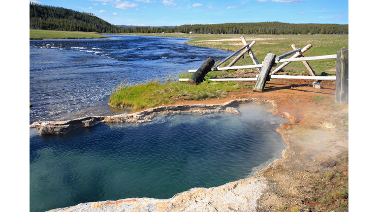 Maidens Grave Hot Spring flowing into the Firehole River in Yellowstone National Park in Wyoming United States