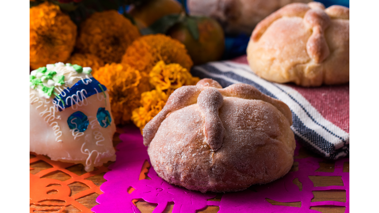 Day of the Dead Offering whit dead bread, sugar skull and cempasuchil flower