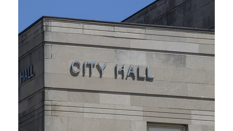 City Hall in silver text set against limestone bricks.