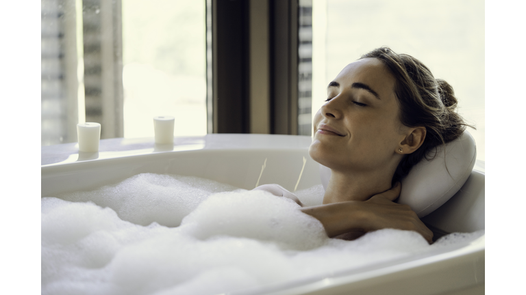 Young woman relaxing in bathtub