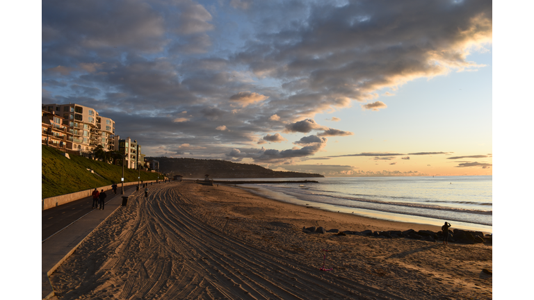 Walkinng along Redondo beach coast during sunset