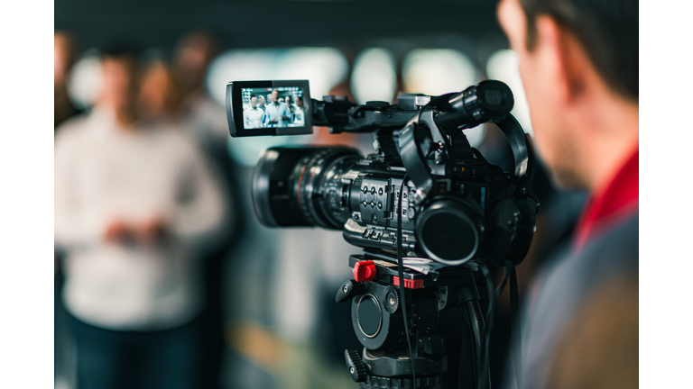 Close-Up Of Cameraman Filming In Studio