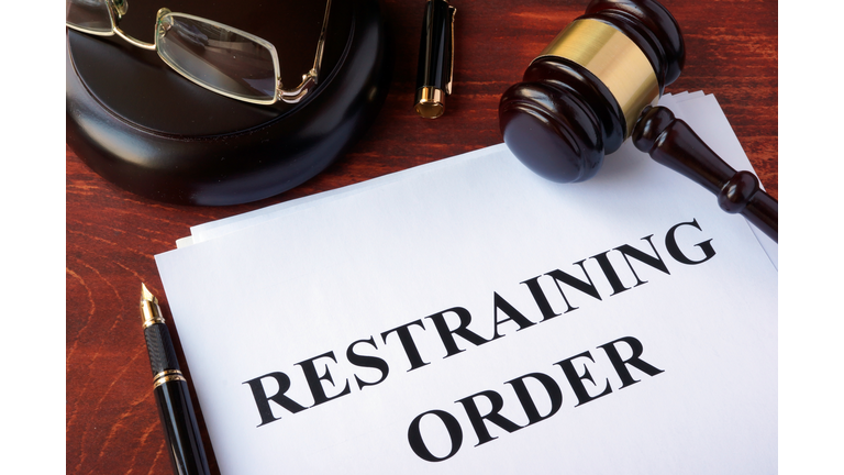 Restraining order and gavel on a table.