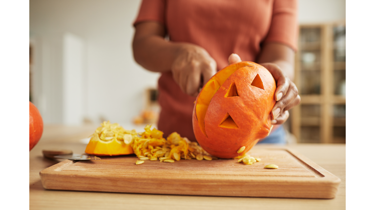 Unrecognizable Woman Carving Pumpkin