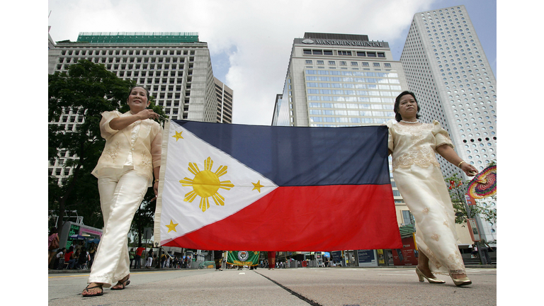 Filipino overseas workers carry their na...