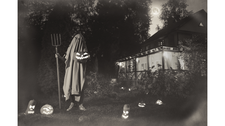 Spooky ghost near haunted house at Halloween in vintage style