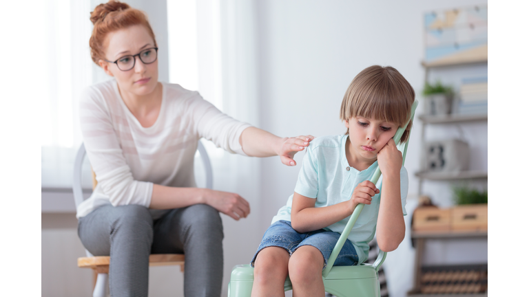 Sad autistic boy and psychotherapist