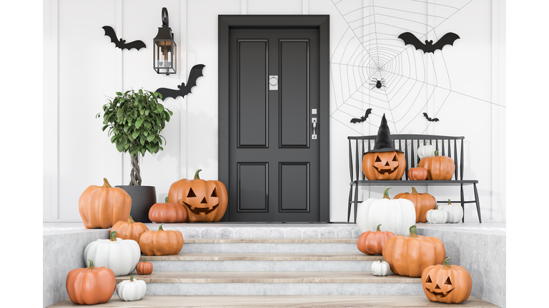 Carved pumpkins on stairs of white house