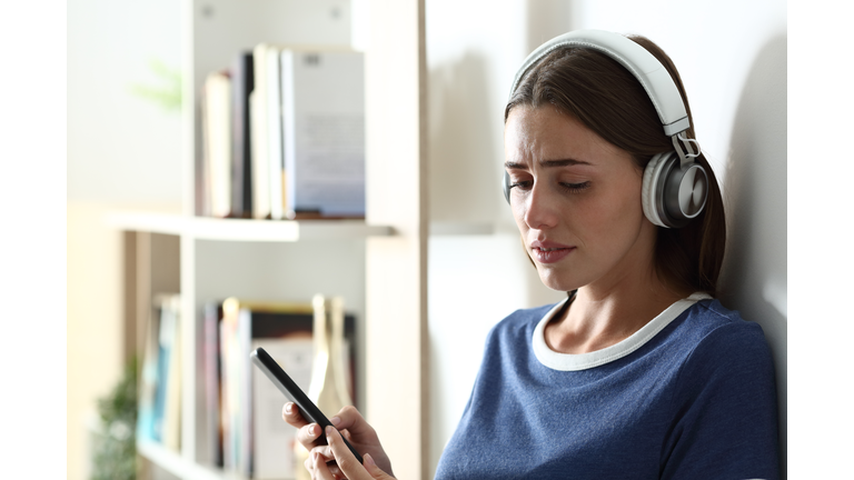 Sad teen complaining listening to music