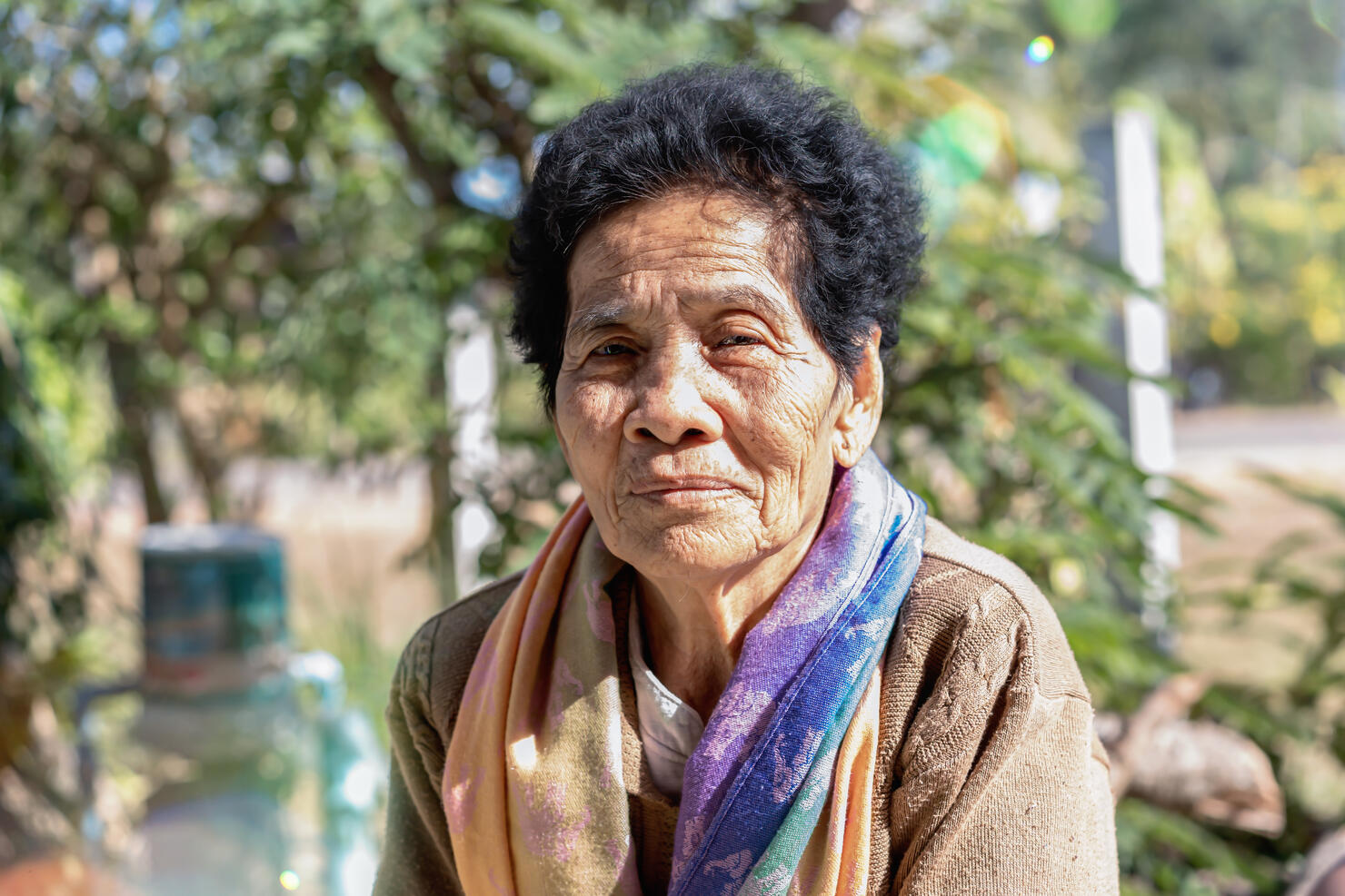 Close-up of old Asian woman face with wrinkles elderly senior"nsmiling happiness, and looking at the camera. Asian senior woman healthy and have positive thoughts on life. Healthcare concept