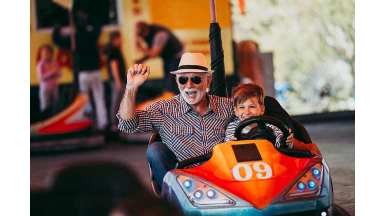 Grandfather and grandson amusement park fun