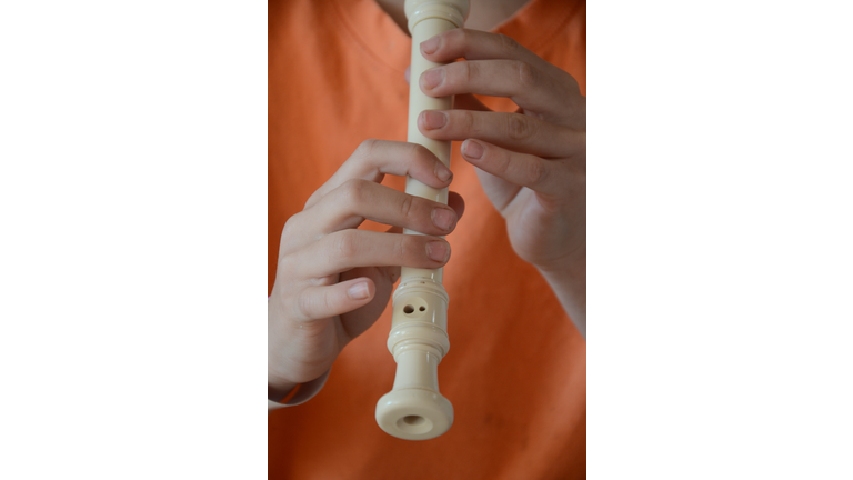 Midsection Of Man Playing Flute