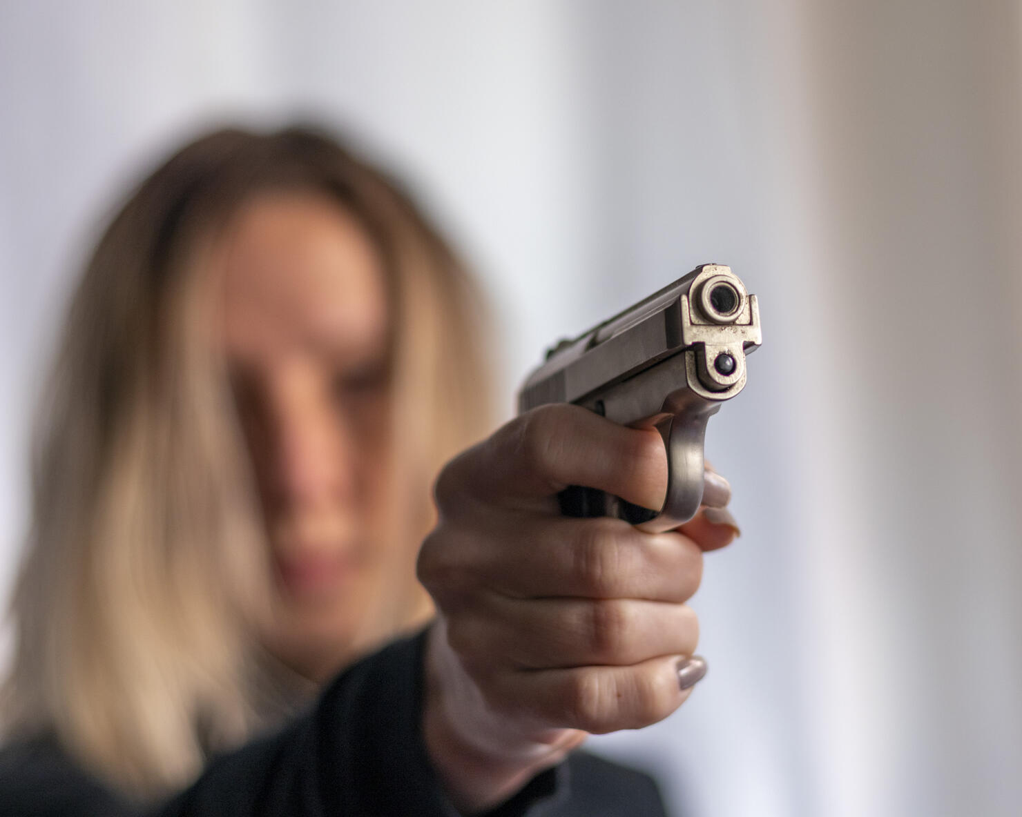 Blonde girl with gun