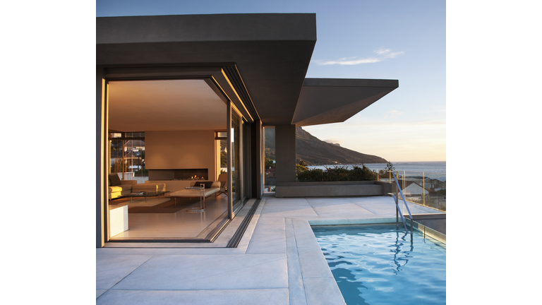 Modern living room and patio next to swimming pool