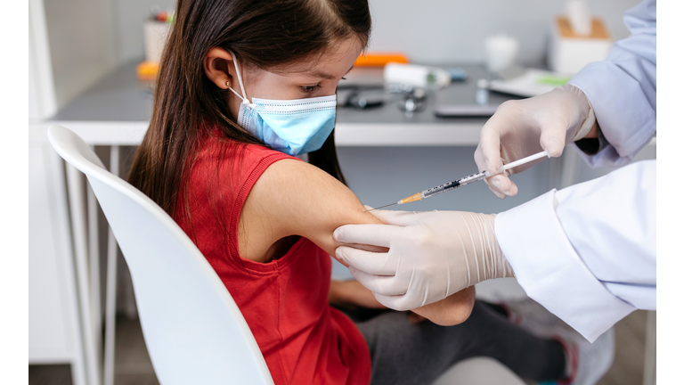 Girl receiving coronavirus vaccine at doctor's office