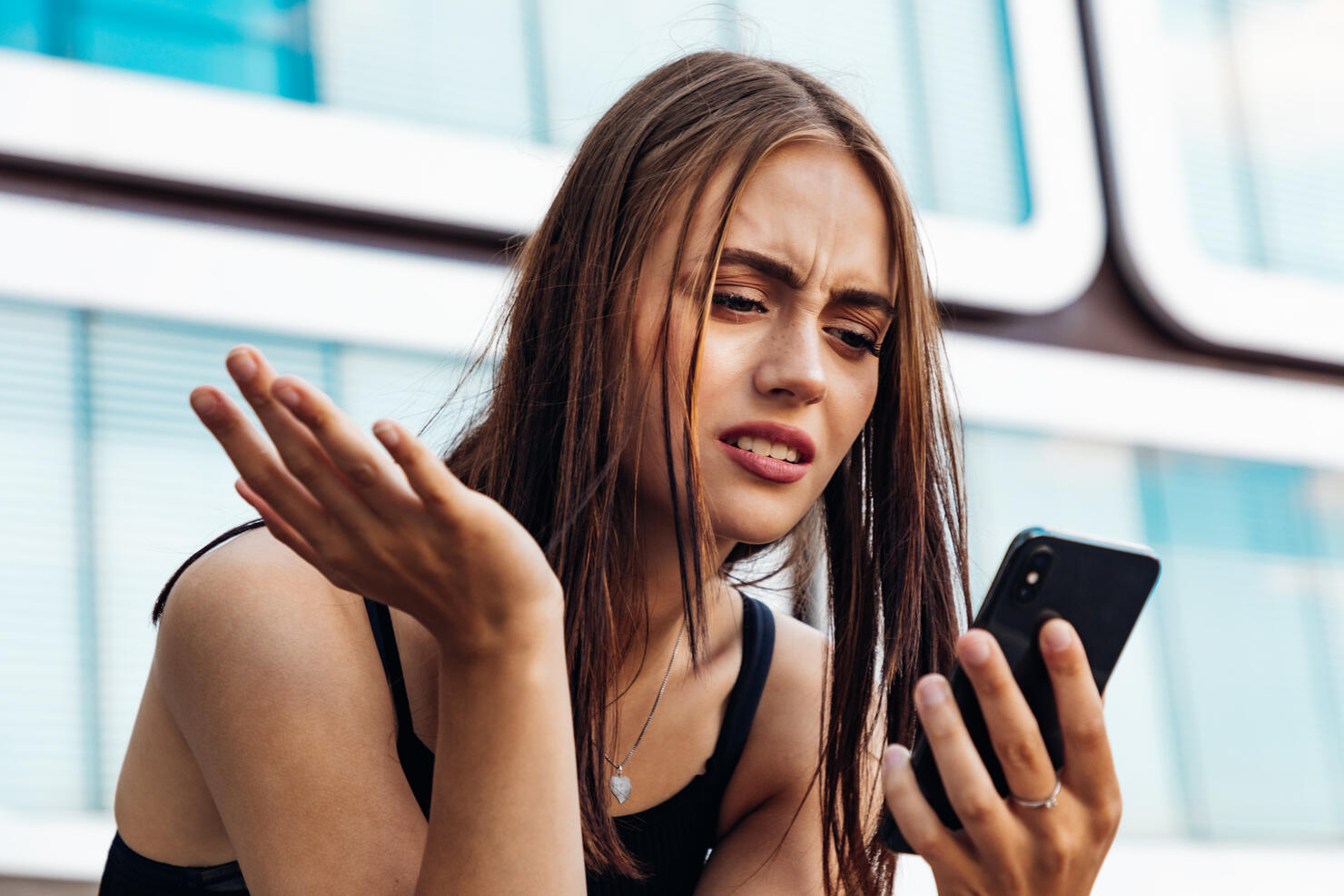 Bad News Young Woman Reading Messages on Mobile Phone