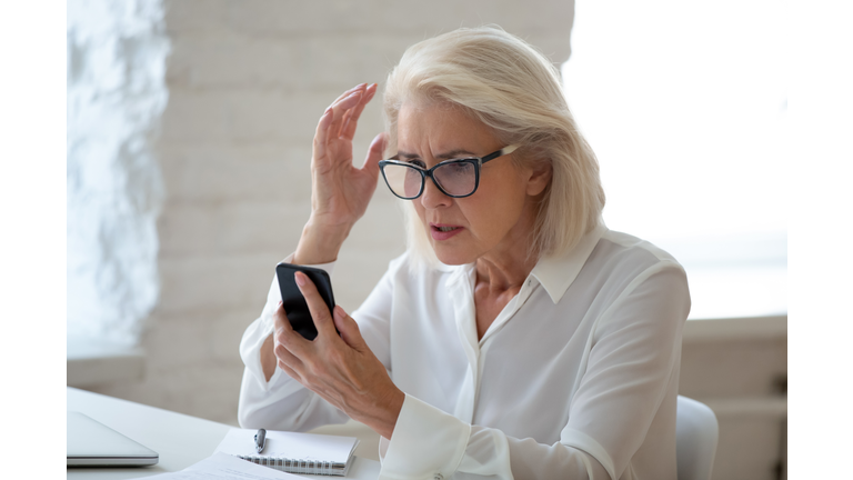 Frustrated woman hold cellphone having device troubles