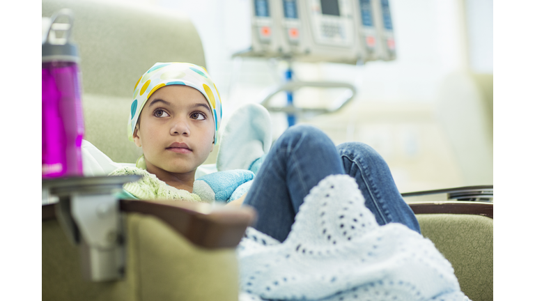 Young cancer patient (8-9) sitting in hospital room