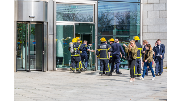 Firefighters outside office building.