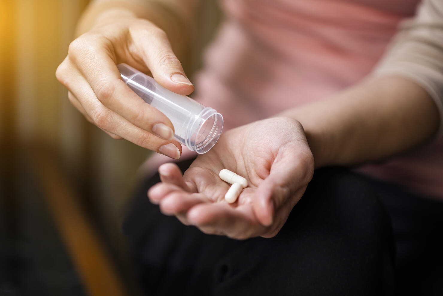 Woman taking pills close-up