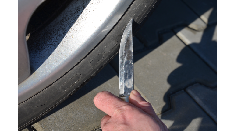 man with a big hunting knife in the parking lot is about to stab, cut the tire. revenge to a neighbor, her mistress's husband, for poor parking at the entrance, envy of a nice car, terrorist attack