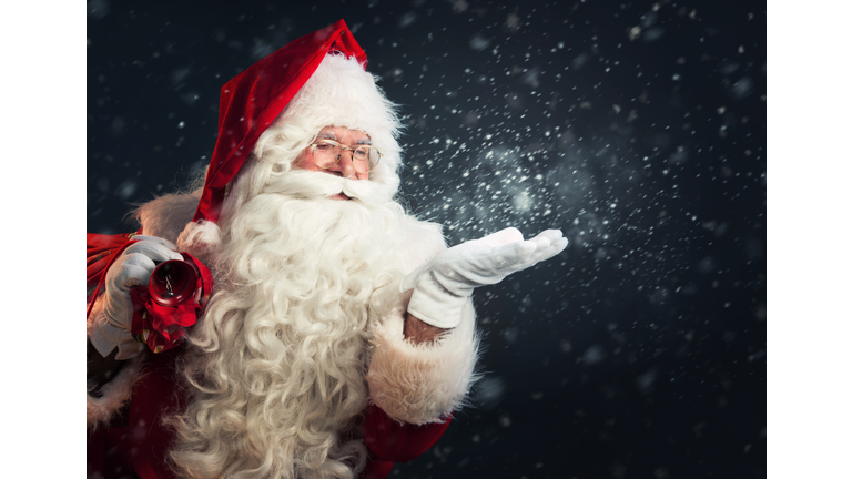 Santa Claus blowing magic snow of his hands