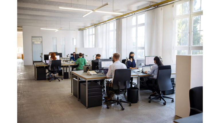 People working in office after reopening of business