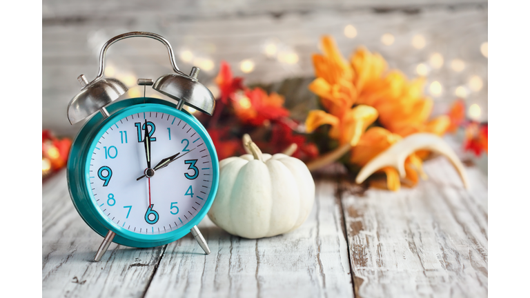 Daylight Savings Time with Clock and White Pumpkin