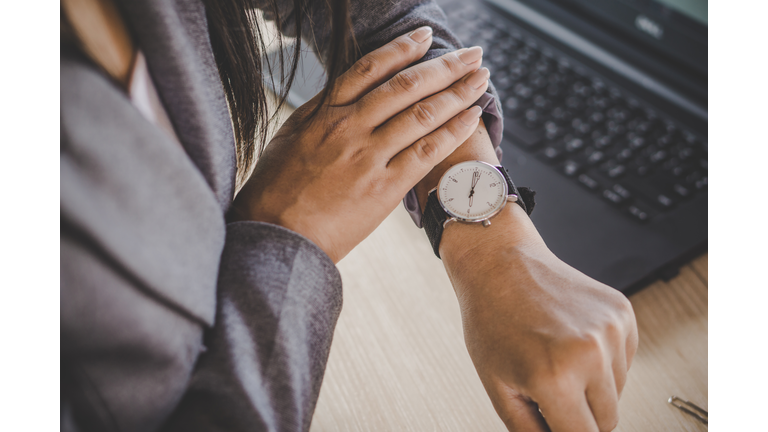 businesswoman checking the time on watch