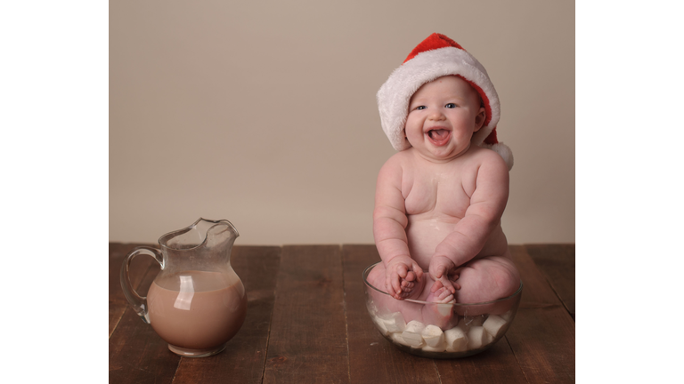 Happy Baby Wearing Santa Hat  Sitting in Bowl of Marshmellows