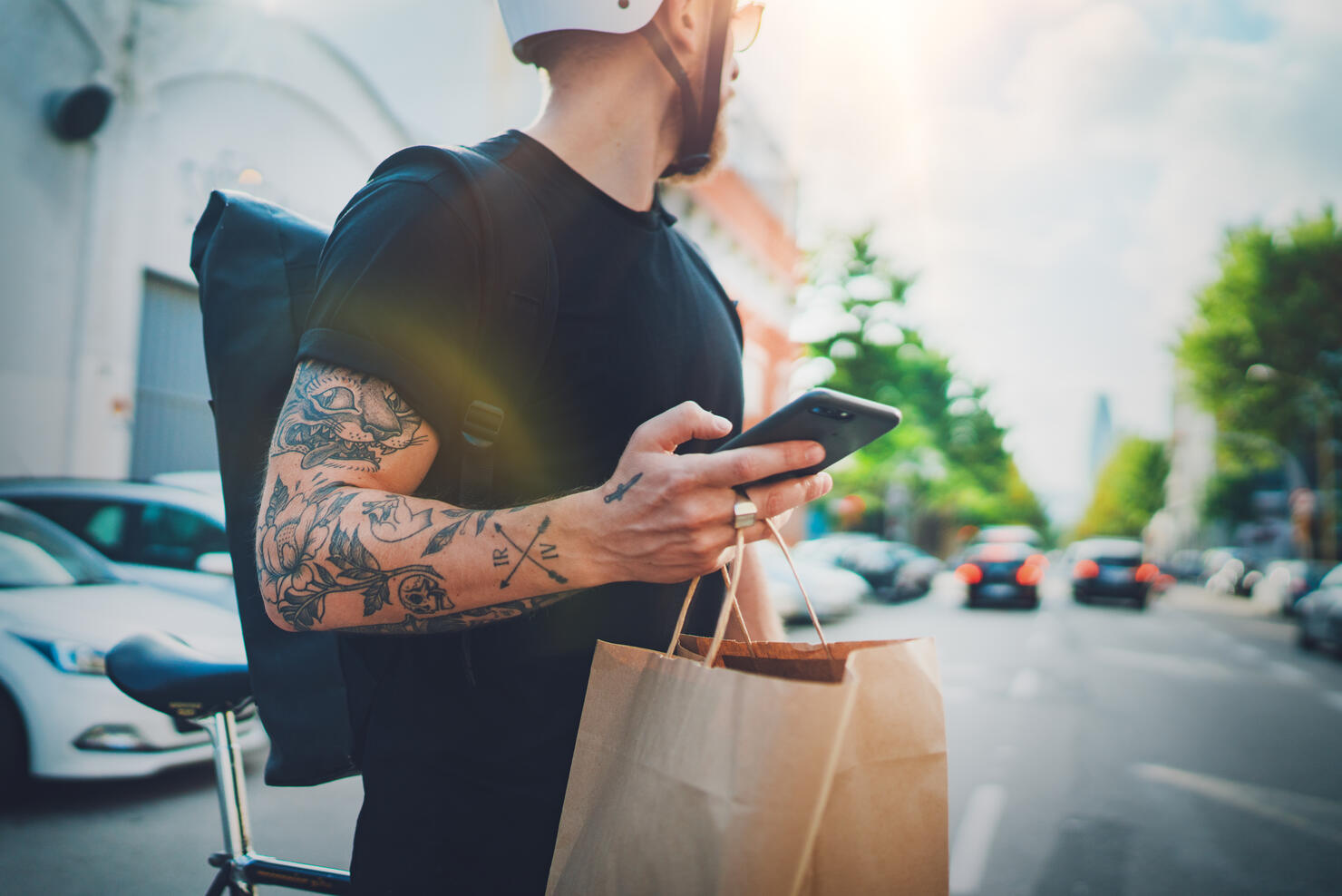 Courier delivery food service at home. Man courier using a map app on mobile phone to find the delivery address in the city