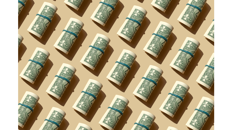 Roll of American dollars banknotes on the beige background