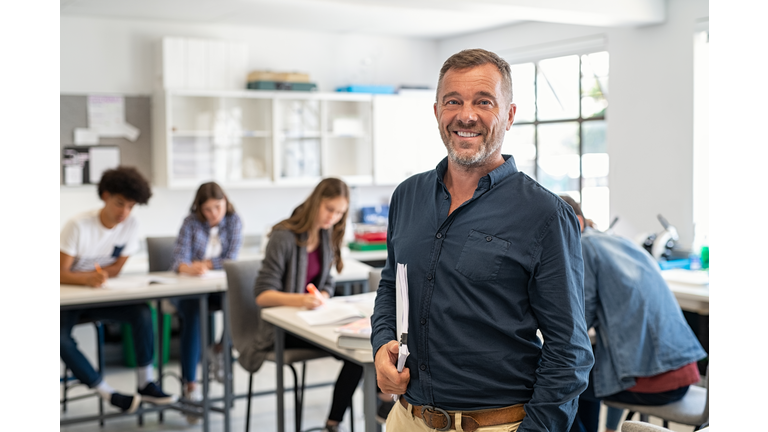 Mature man professor standing in class