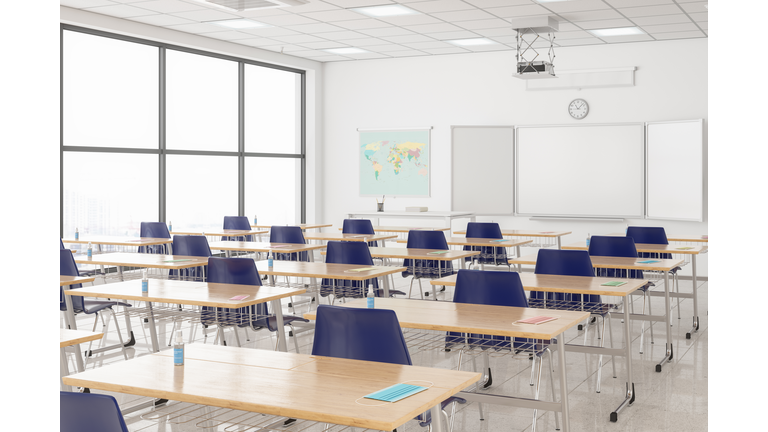 Protective Face Masks And Hand Sanitizers On The Desks According To New Normal Concept In An Empty Classroom.