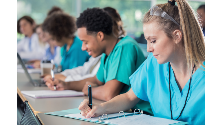 Focus medical students take notes during lecture