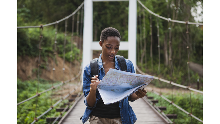 African American woman looking at a map travel and explore concept