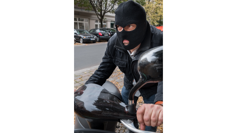 Theft wearing a balaclava stealing a scooter