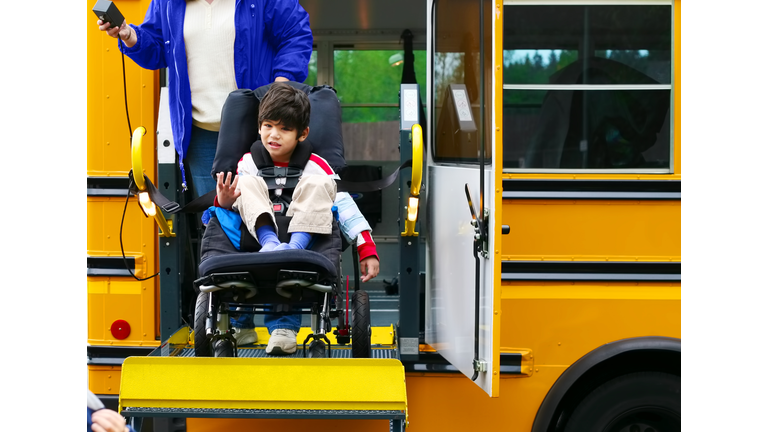 Disabled five year old boy using a wheelchairbus lift